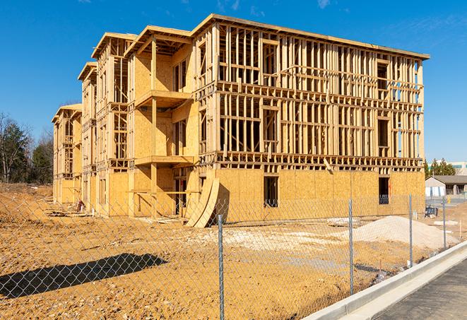 a temporary chain link fence winding around a construction site, outlining the project's progress in Clayton OH